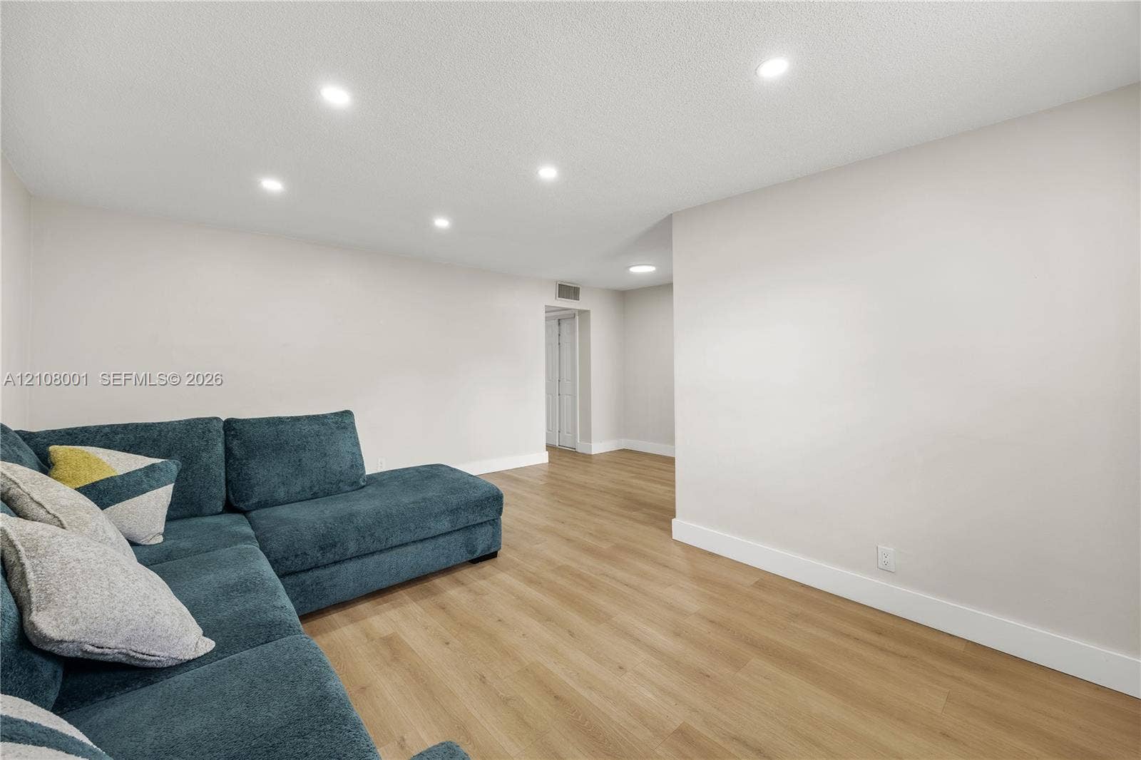2418 Polk Street, #105, Hollywood, Hollywood, FL 33020 Interior space featuring wood-finish flooring, recessed lighting, and neutral wall paint
