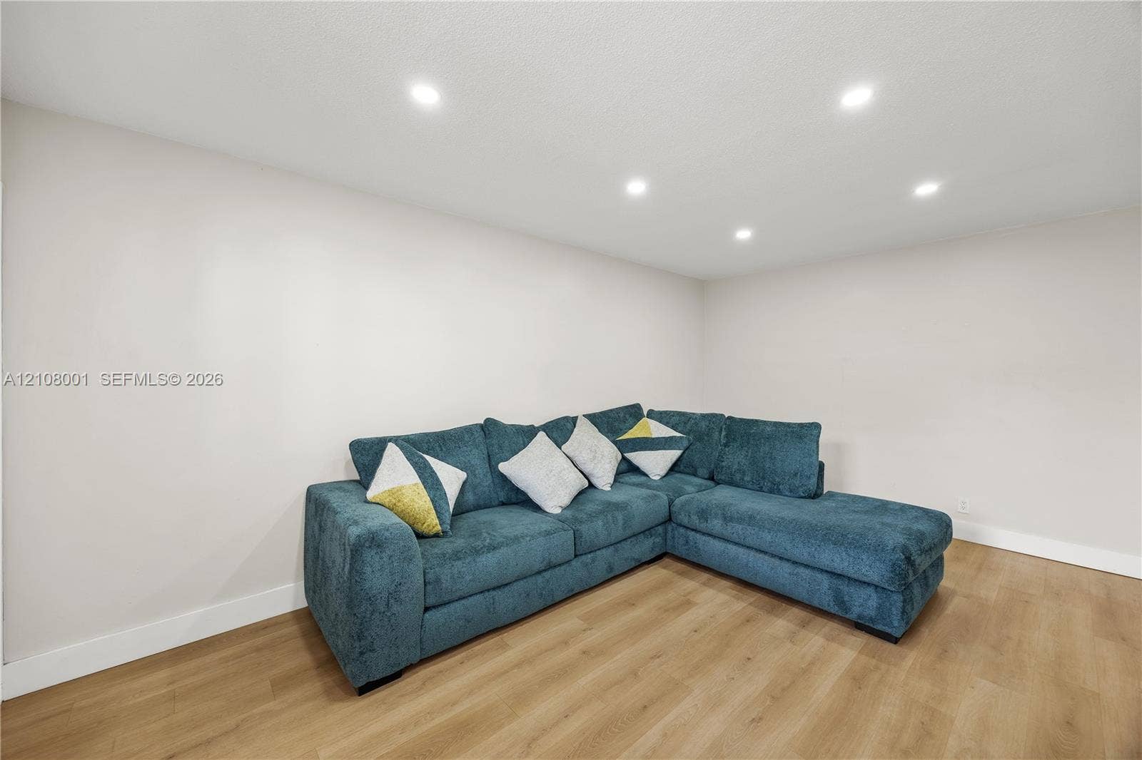 2418 Polk Street, #105, Hollywood, Hollywood, FL 33020 Neutral wall paint, wood-finish flooring, and recessed ceiling lighting