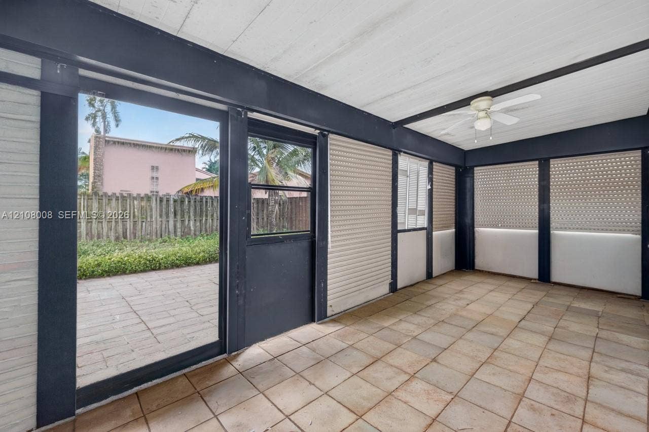 16708 SW 5th Way, Weston, Weston, FL 33326 Enclosed patio featuring tile flooring, painted wood-panel ceiling, dark structural framing, ceiling fan, and sliding glass door access to a paved exterior area
