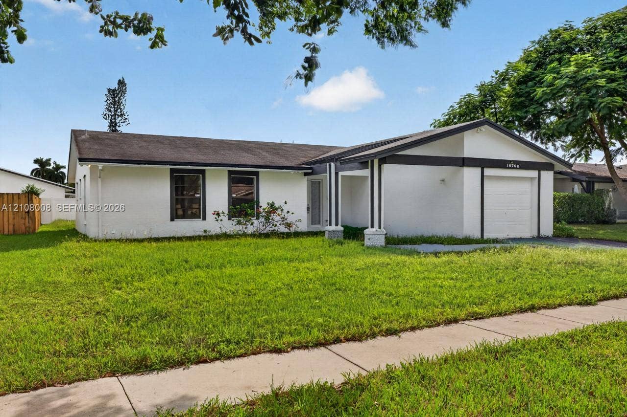 16708 SW 5th Way, Weston, Weston, FL 33326 Single-story exterior featuring painted masonry siding, a covered entryway with structural columns, and an attached one-car garage