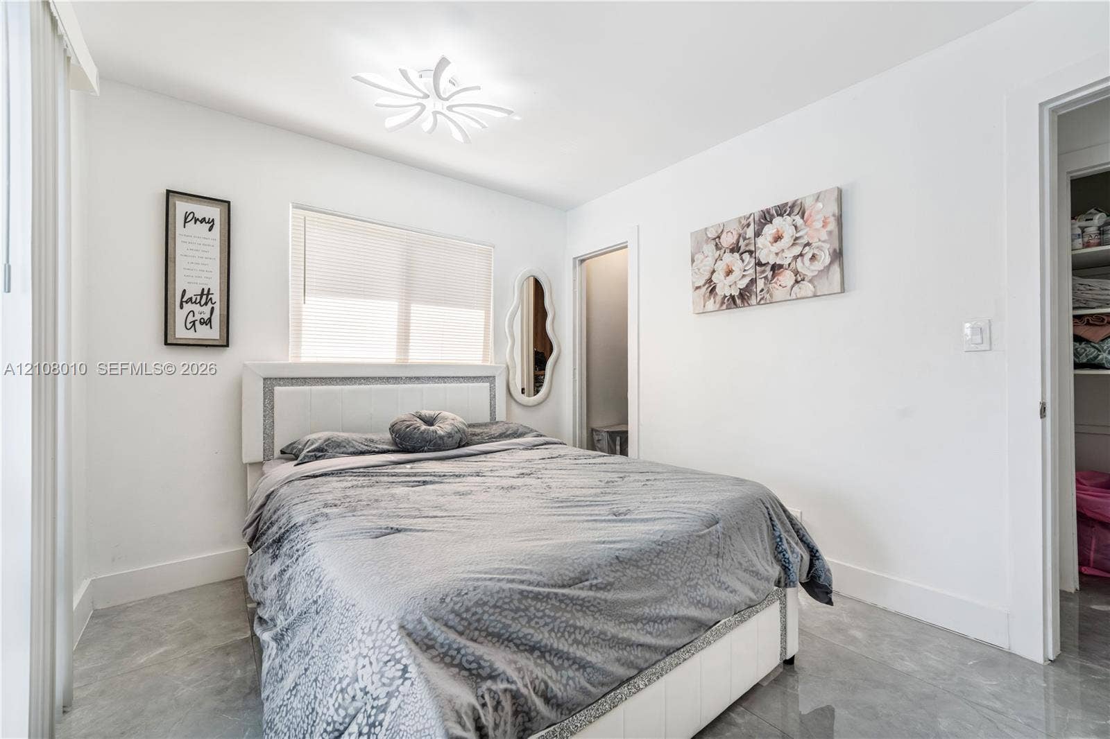 Neutral-toned stone-finish tile flooring, recessed ceiling lighting with a modern multi-point design, and a walk-in closet