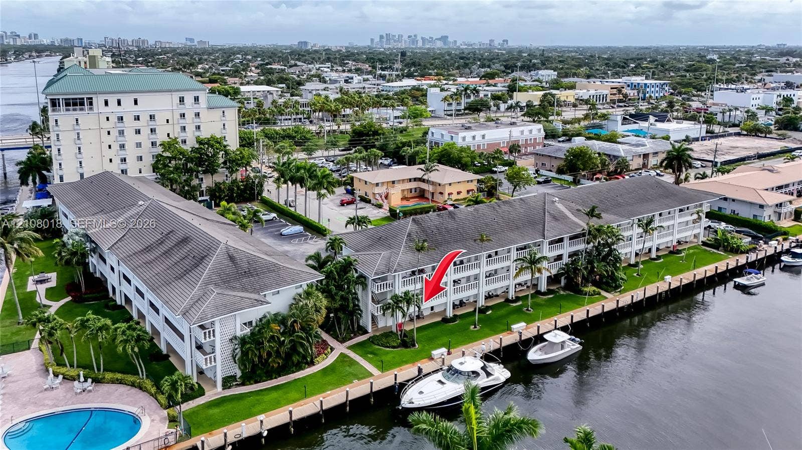 Waterfront condominium featuring deep-water dockage, ground-level green space, and multi-story balcony access along the canal