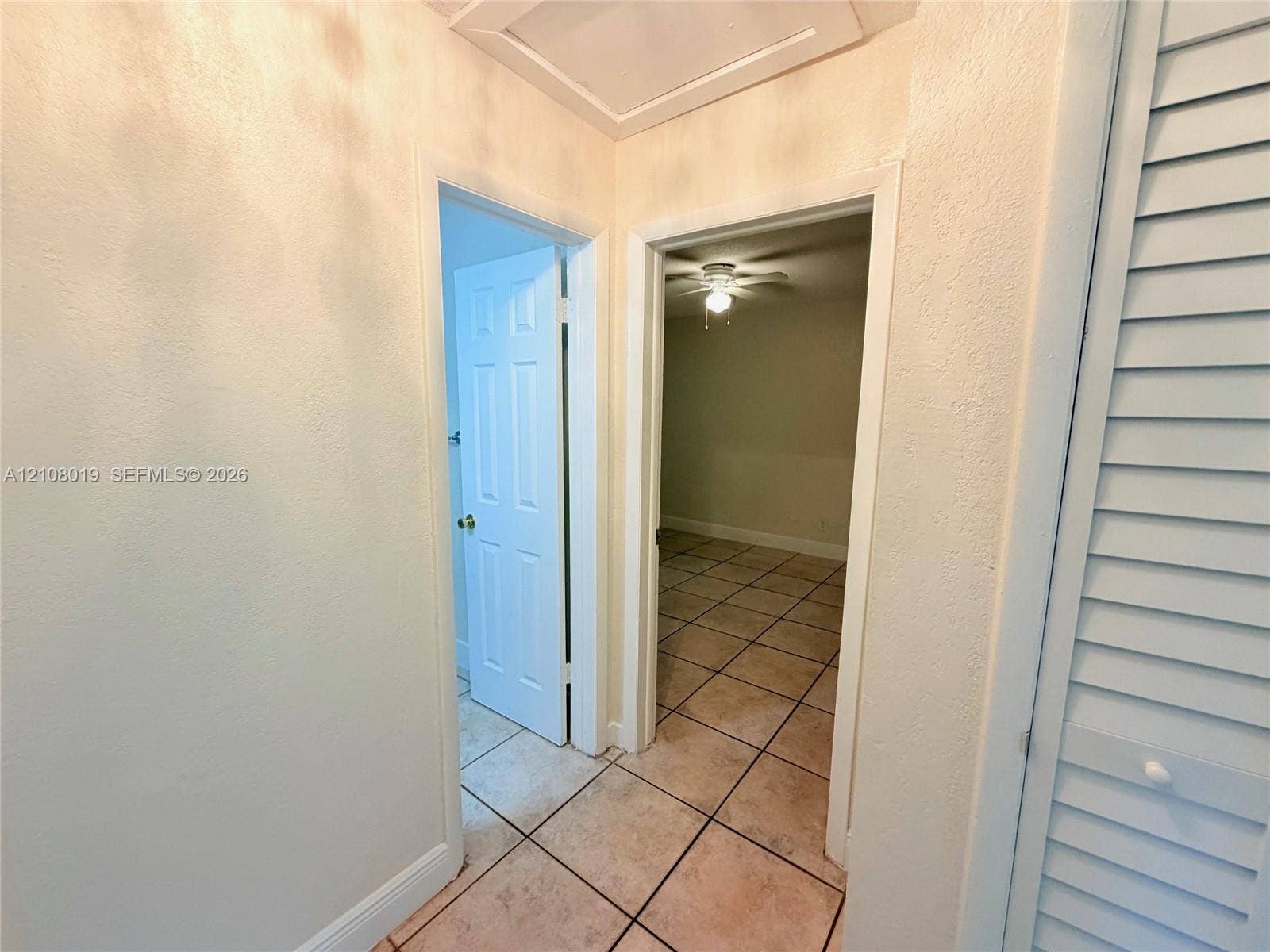 1105 NE 5th Terrace, #1-4, Fort Lauderdale, Fort Lauderdale, FL 33304 Hallway featuring ceramic tile flooring, six-panel interior doors, and louvered closet doors