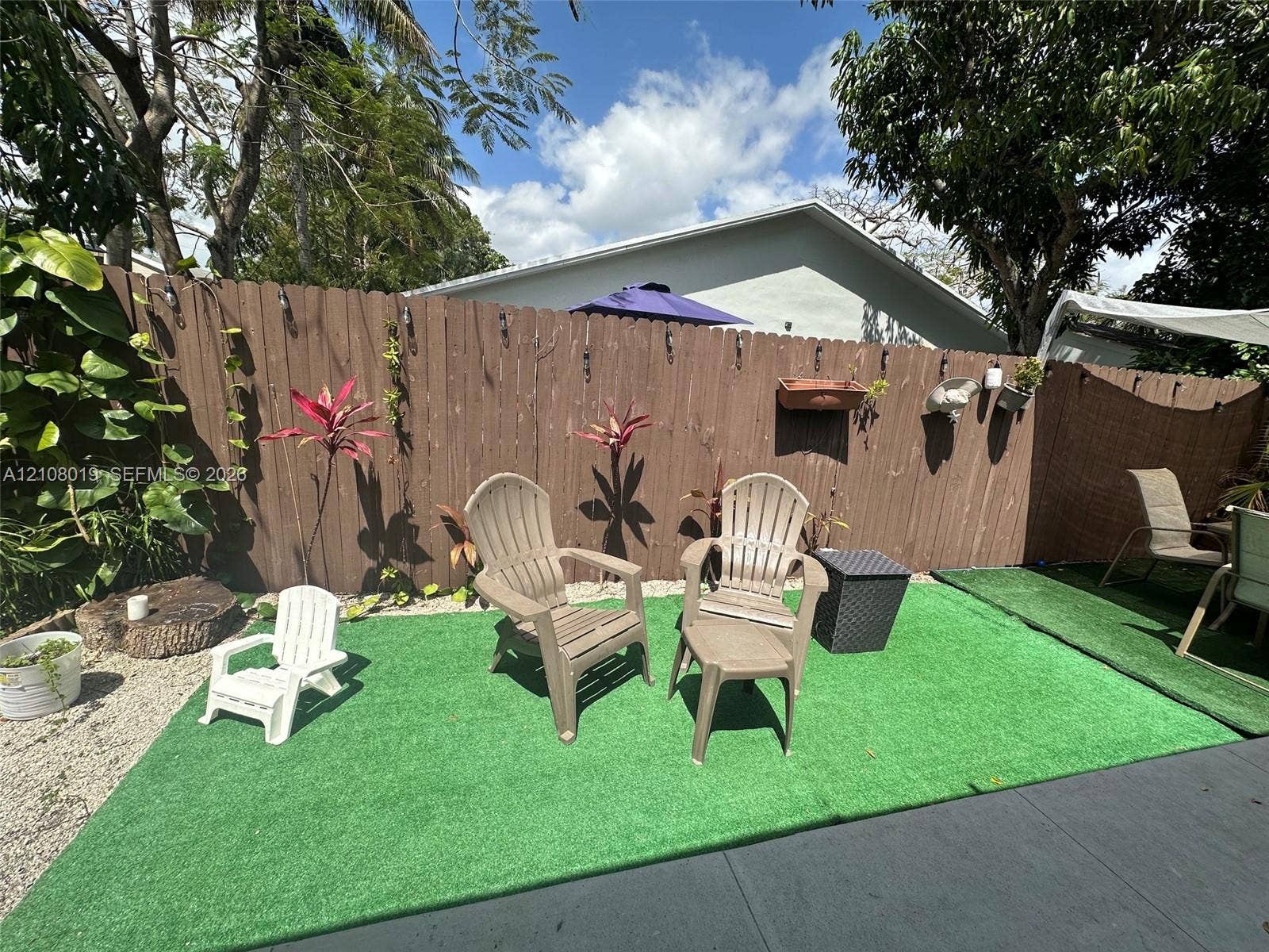1105 NE 5th Terrace, #1-4, Fort Lauderdale, Fort Lauderdale, FL 33304 Fenced backyard featuring privacy screening, artificial turf, gravel hardscaping, and mature trees