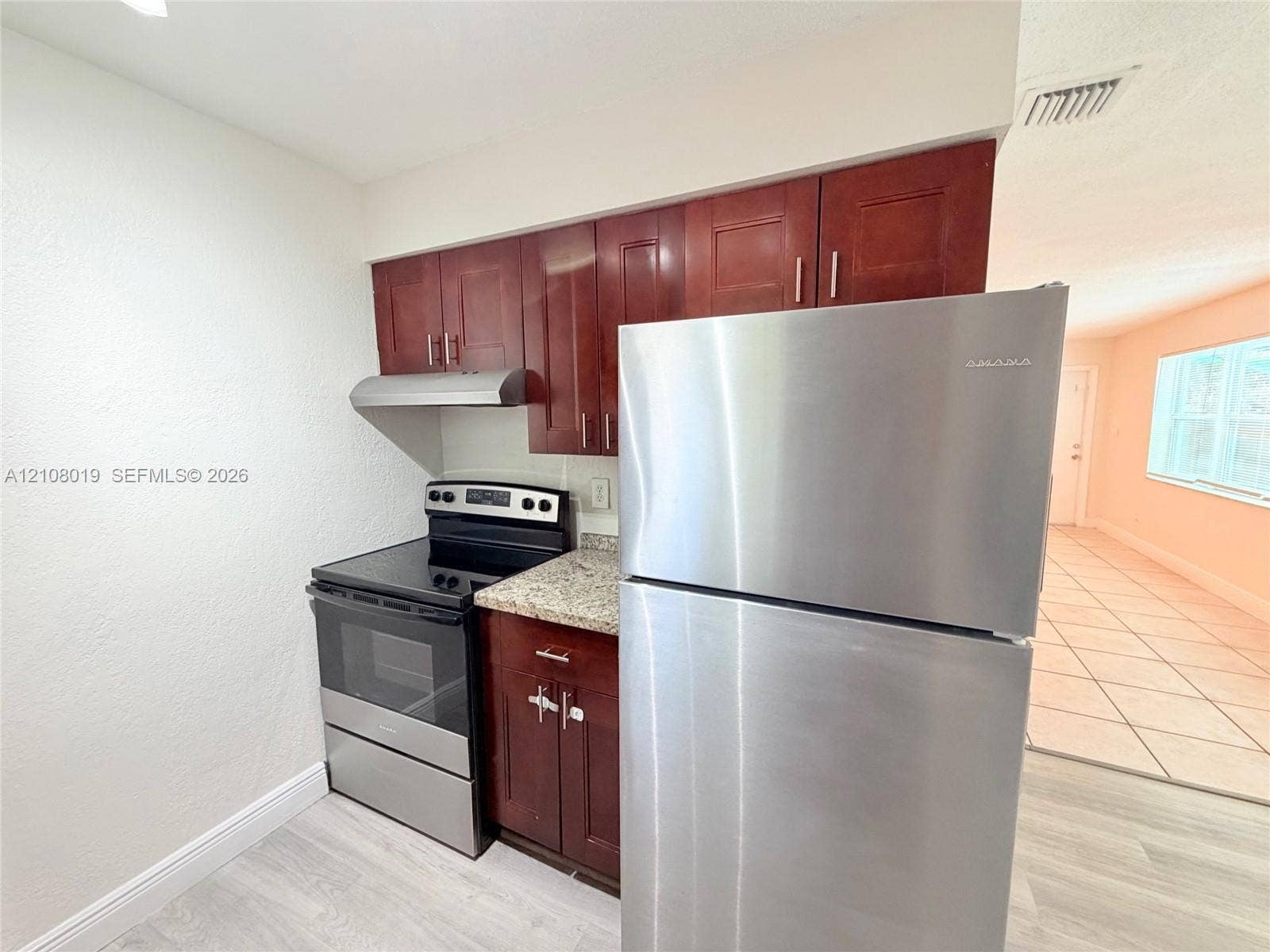 1105 NE 5th Terrace, #1-4, Fort Lauderdale, Fort Lauderdale, FL 33304 Kitchen featuring stained wood cabinetry, stone-finish countertops, and stainless steel appliances