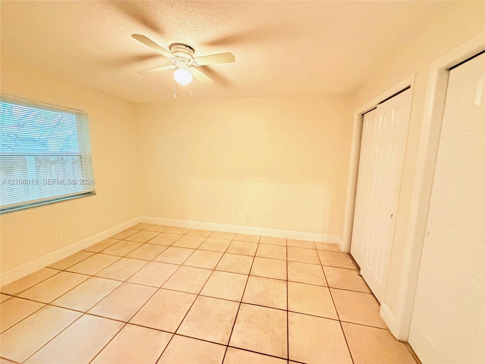 1105 NE 5th Terrace, #1-4, Fort Lauderdale, Fort Lauderdale, FL 33304 Tile flooring, white bi-fold closet doors, and a ceiling fan with integrated lighting