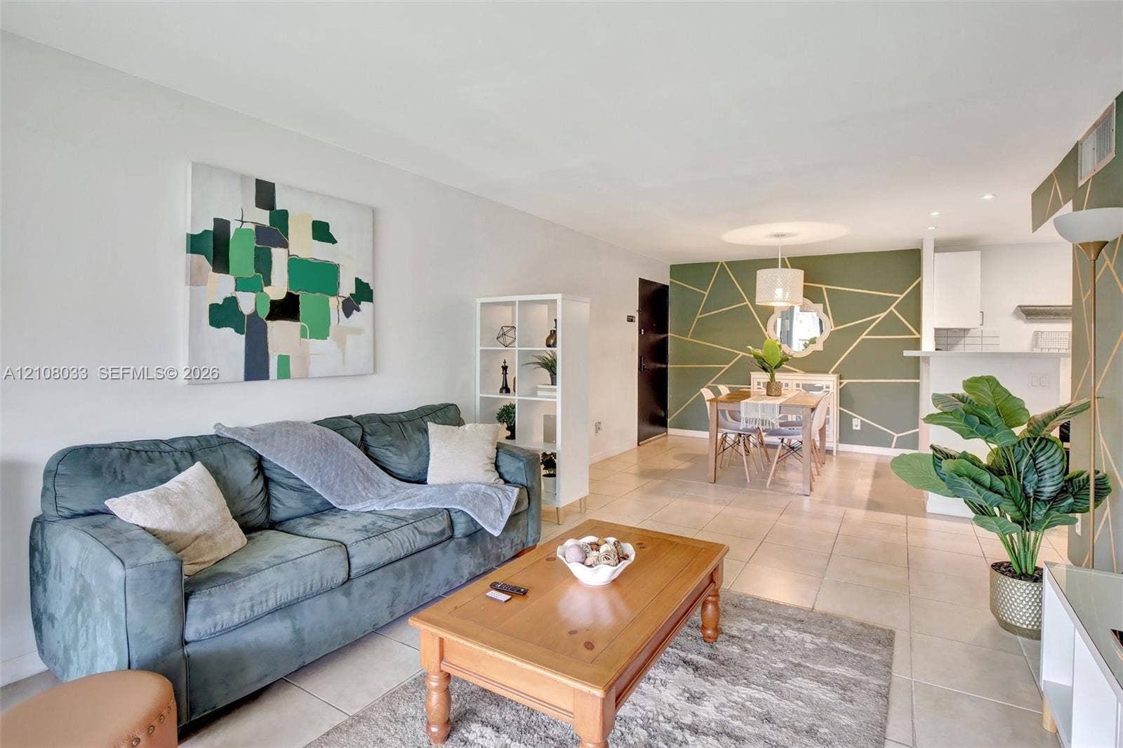 5821 Washington Street, #30, Hollywood, Hollywood, FL 33023 Open-concept interior featuring neutral tile flooring, an accent wall with geometric wall molding, and recessed lighting