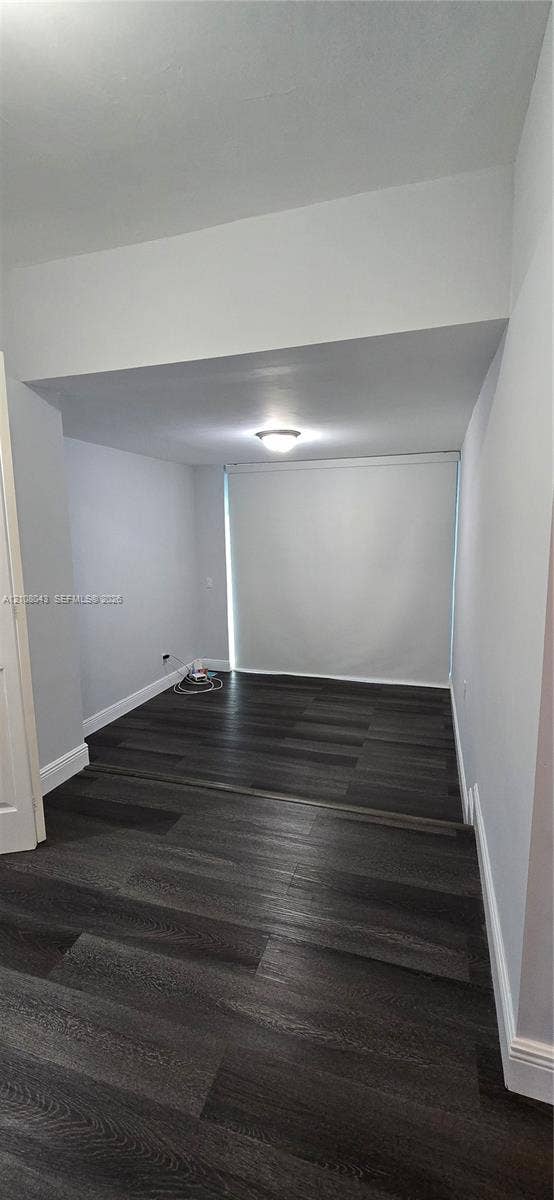 7176 SW 12th Street, #7176, Miami, Miami, FL 33144 Interior space featuring dark wood-finish flooring, recessed architectural soffit, and flush-mount ceiling lighting