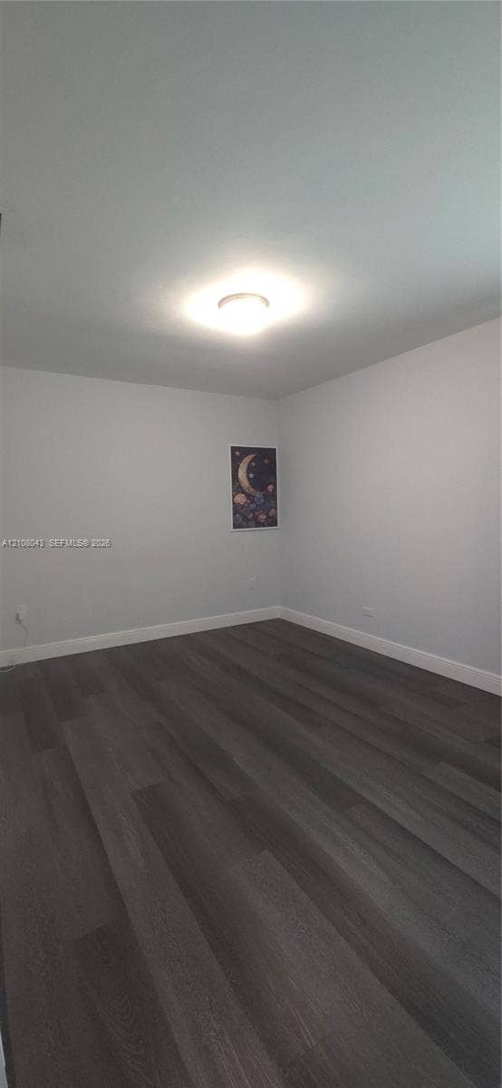 7176 SW 12th Street, #7176, Miami, Miami, FL 33144 Room featuring neutral wall paint, dark wood-finish flooring, and a flush-mount ceiling fixture