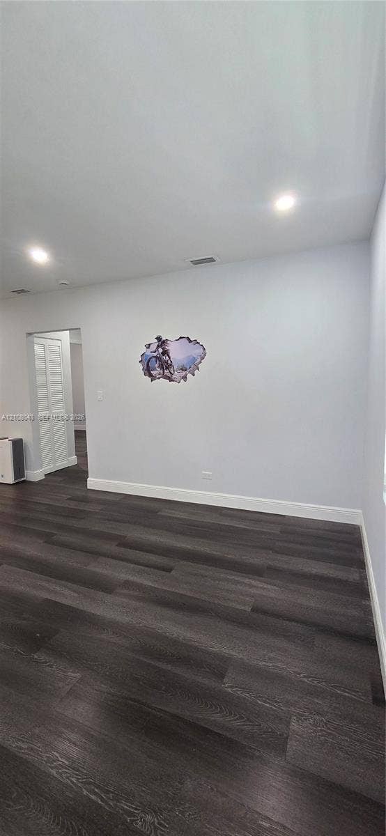 7176 SW 12th Street, #7176, Miami, Miami, FL 33144 Interior space featuring dark wood-finish flooring, recessed ceiling lighting, and a bi-fold door