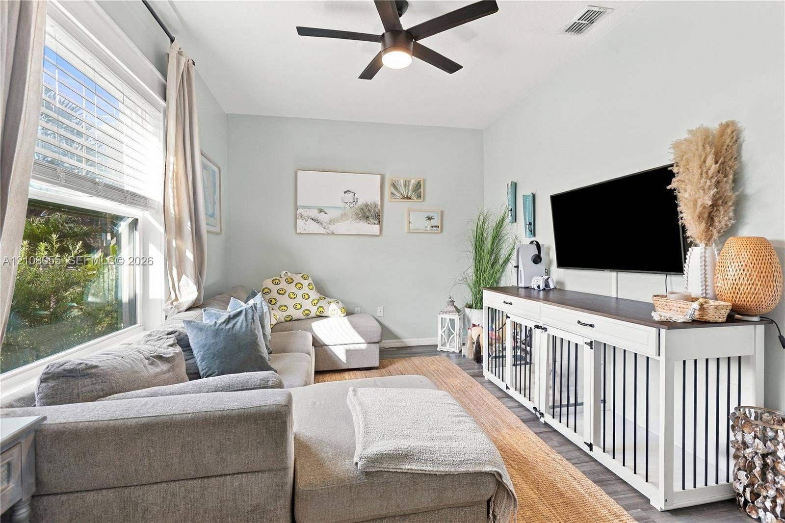 557 SW Lacroix Avenue, Port St Lucie, FL 34953 Room featuring a multi-pane window, ceiling fan with light fixture, and neutral wall color