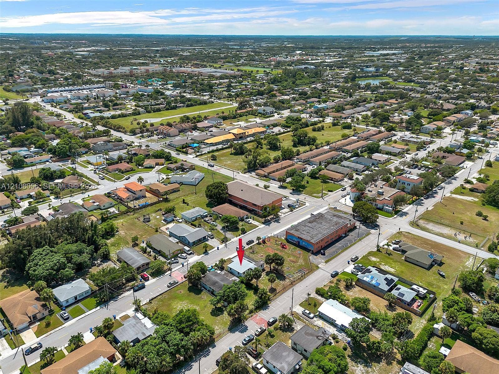 1444 W 28th Street, Riviera Beach, FL 33404 Aerial perspective featuring a corner lot property with established vegetation and street-level access