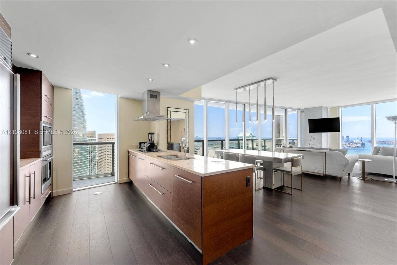 495 Brickell Avenue, #4502, Miami, FL 33131 Kitchen featuring flat-panel wood cabinetry, stone countertops, stainless steel appliances, wood-finish flooring, and floor-to-ceiling windows