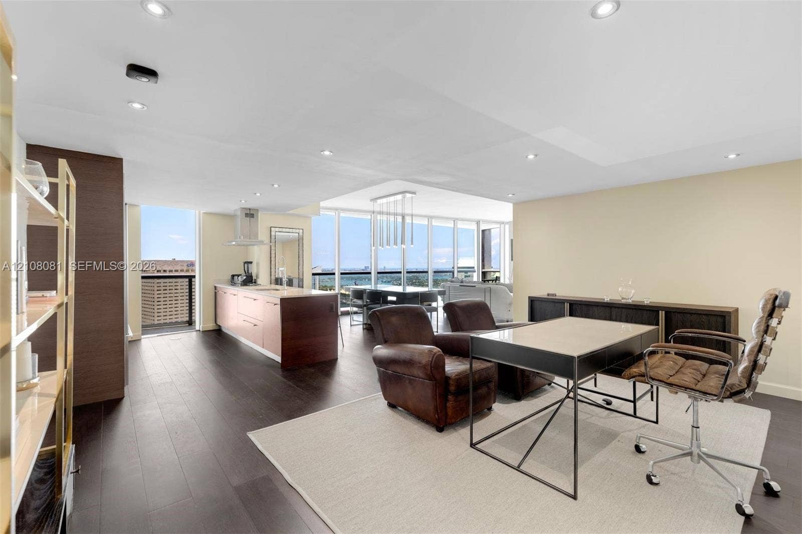 495 Brickell Avenue, #4502, Miami, FL 33131 Open-concept interior featuring wood-finish flooring, floor-to-ceiling windows, recessed lighting, and kitchen island with integrated cabinetry