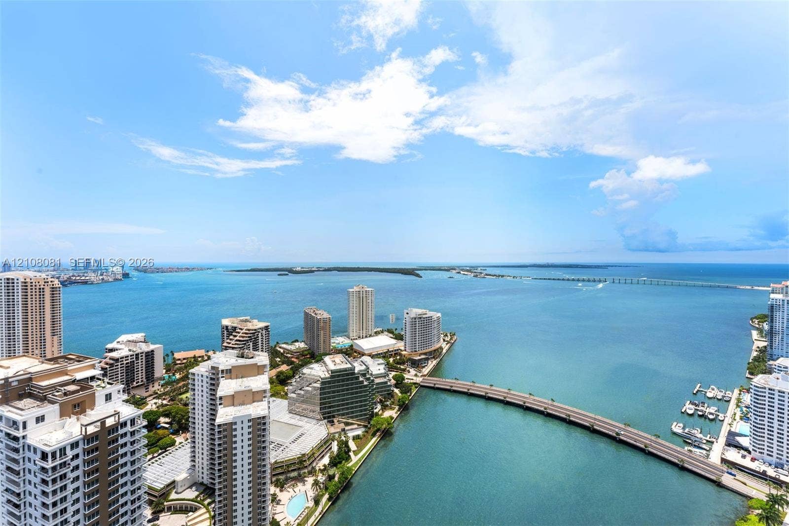 495 Brickell Avenue, #4502, Miami, FL 33131 Elevated perspective featuring coastal water, bridge infrastructure, high-rise urban density, and open horizon