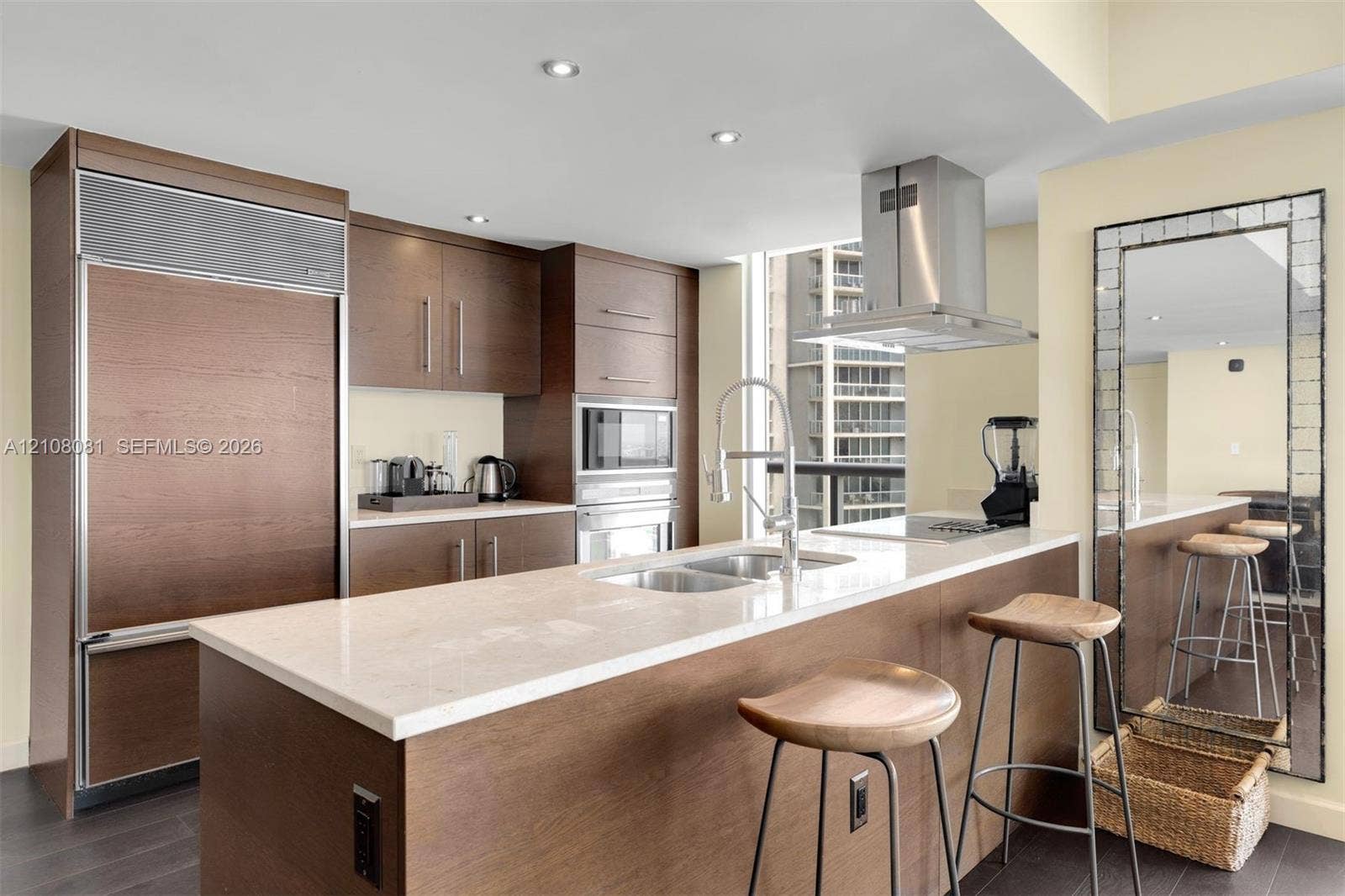 495 Brickell Avenue, #4502, Miami, FL 33131 Kitchen featuring wood-finish cabinetry, stone-surface countertops, stainless steel appliances, stainless steel range hood, and recessed lighting
