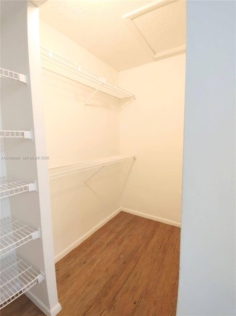 4401 W Mcnab Road, Pompano Beach, FL 33069 Storage space featuring wood-finish flooring and white wire shelving units