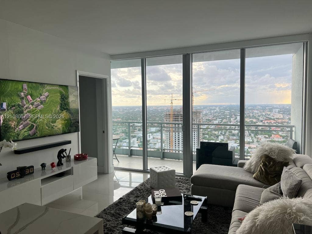 92 SW 3rd Street, #5008, Miami, Miami, FL 33130 Floor-to-ceiling windows, private balcony with metal railing, and high-gloss white built-in cabinetry