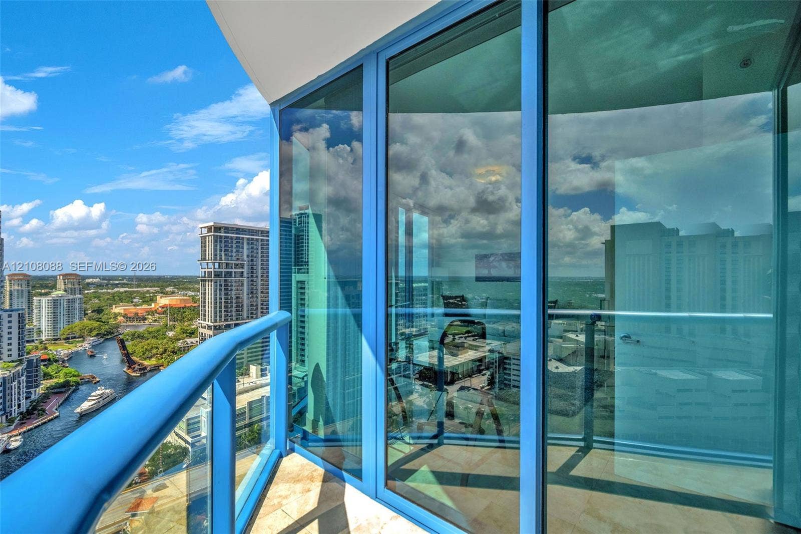 333 Las Olas Way, #2601, Fort Lauderdale, FL 33301 Private balcony featuring floor-to-ceiling glass paneling, metal railings, and stone-tile flooring