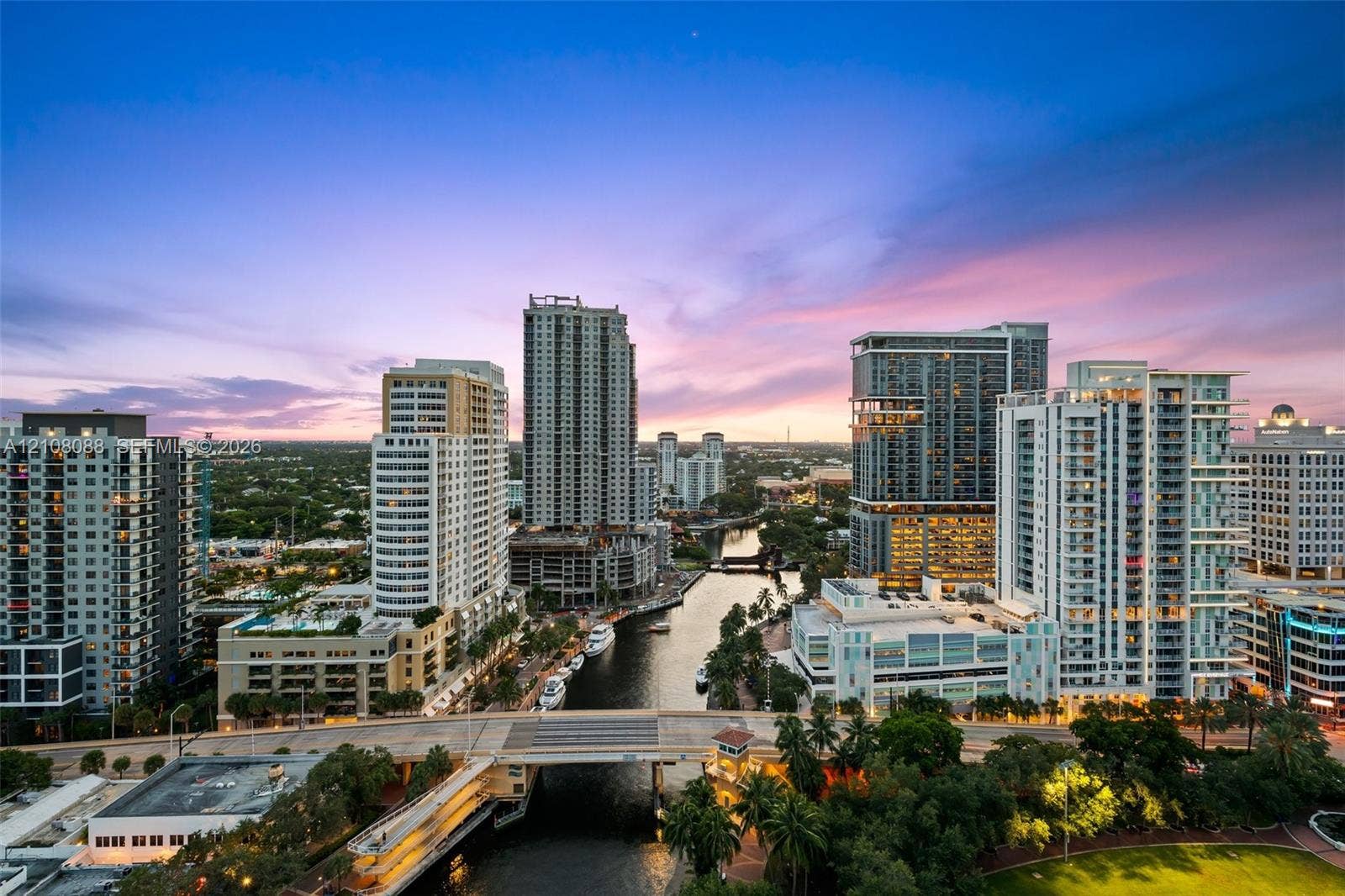 333 Las Olas Way, #2601, Fort Lauderdale, FL 33301 Aerial perspective featuring a metropolitan skyline, a central waterway, bridge infrastructure, and dense urban development