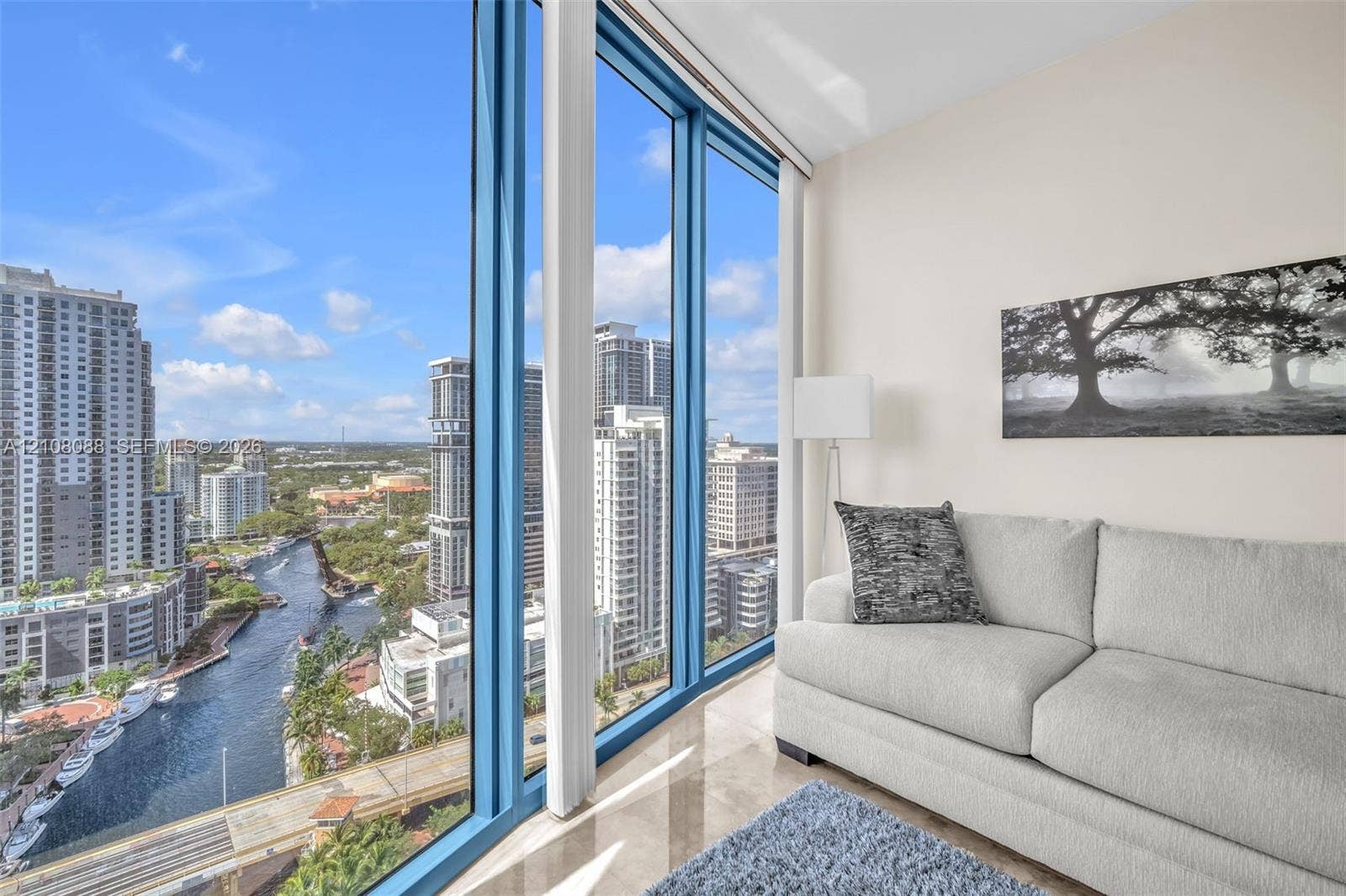 333 Las Olas Way, #2601, Fort Lauderdale, FL 33301 Floor-to-ceiling windows featuring panoramic urban scenery and polished tile flooring