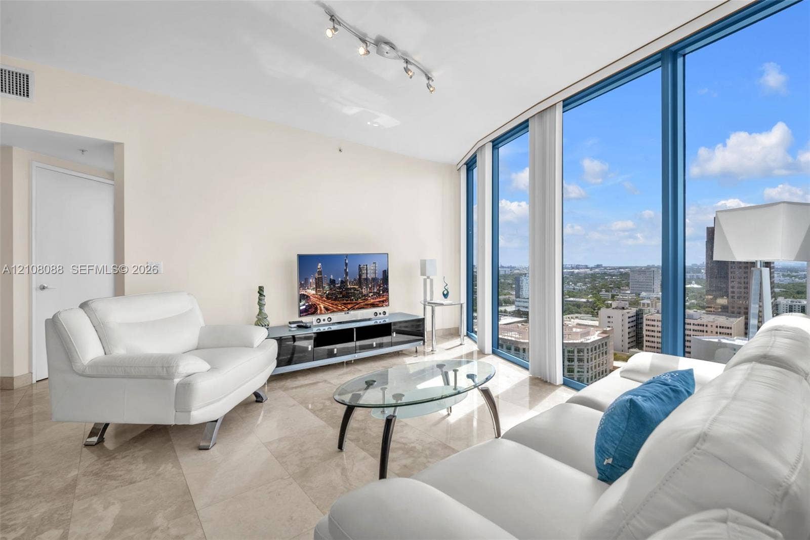 333 Las Olas Way, #2601, Fort Lauderdale, FL 33301 Floor-to-ceiling windows with panoramic urban exposure, polished stone tile flooring, and adjustable track lighting