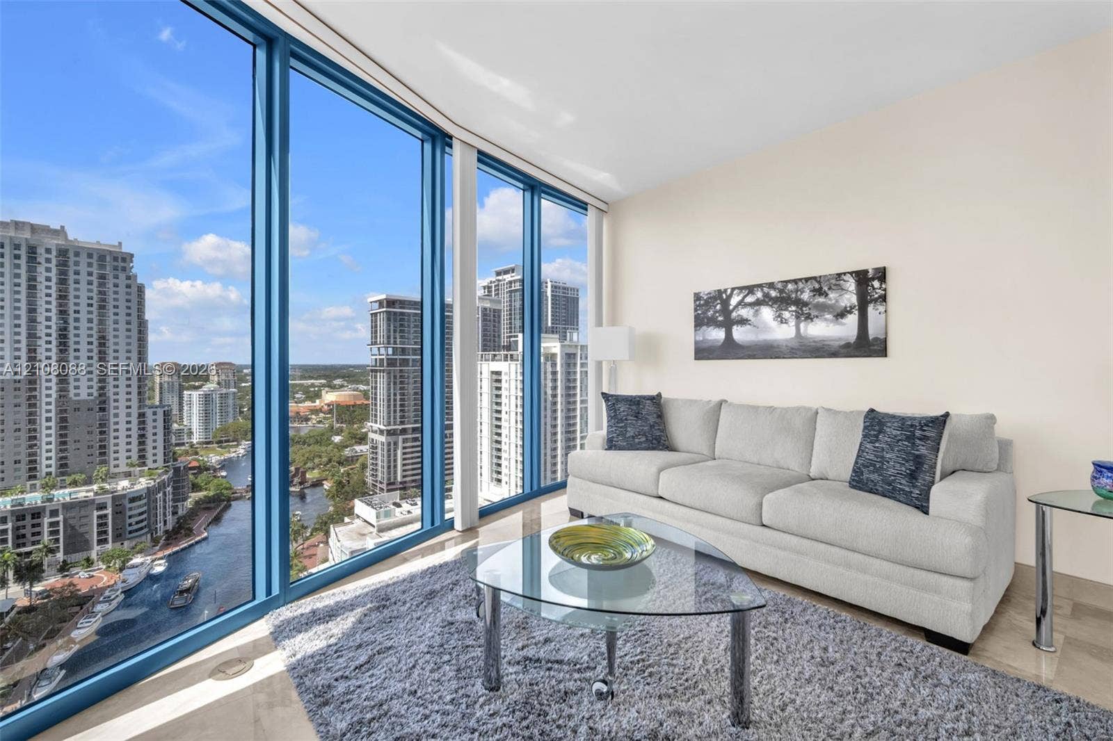 333 Las Olas Way, #2601, Fort Lauderdale, FL 33301 Floor-to-ceiling windows featuring panoramic urban scenery and stone-finish flooring