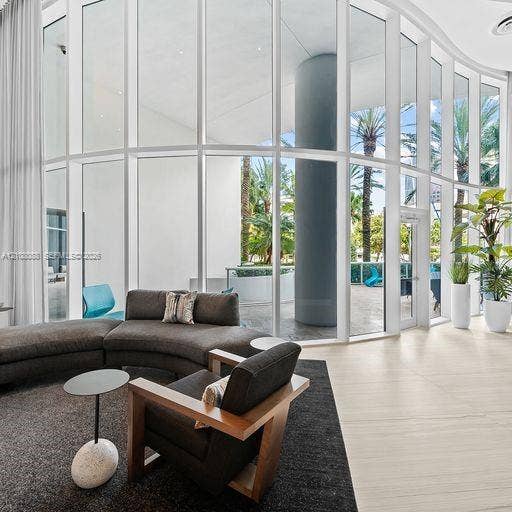 333 Las Olas Way, #2601, Fort Lauderdale, FL 33301 Curved floor-to-ceiling glass wall, light-toned stone tile flooring, and integrated structural column