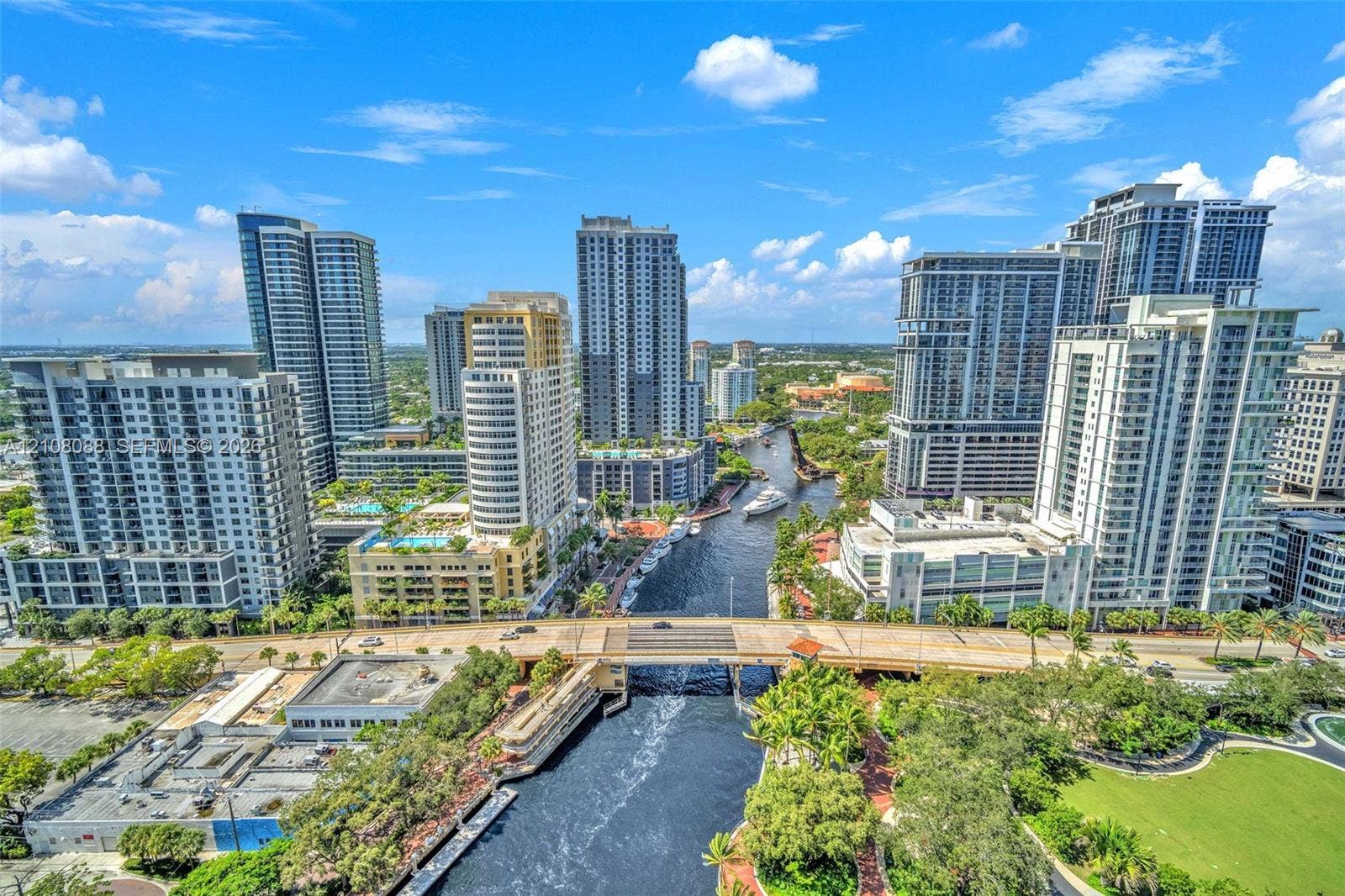 333 Las Olas Way, #2601, Fort Lauderdale, FL 33301 Aerial perspective of a high-density urban corridor featuring a central waterway, bridge infrastructure, mature landscaping, and numerous mid-rise and high-rise structures
