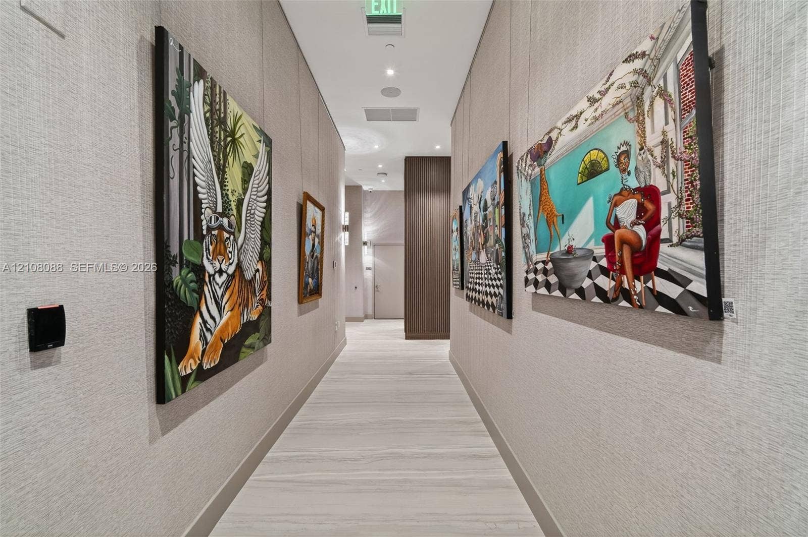 333 Las Olas Way, #2601, Fort Lauderdale, FL 33301 Hallway featuring textured wall coverings, recessed ceiling lighting, wood-finish flooring, and wood-panel accents