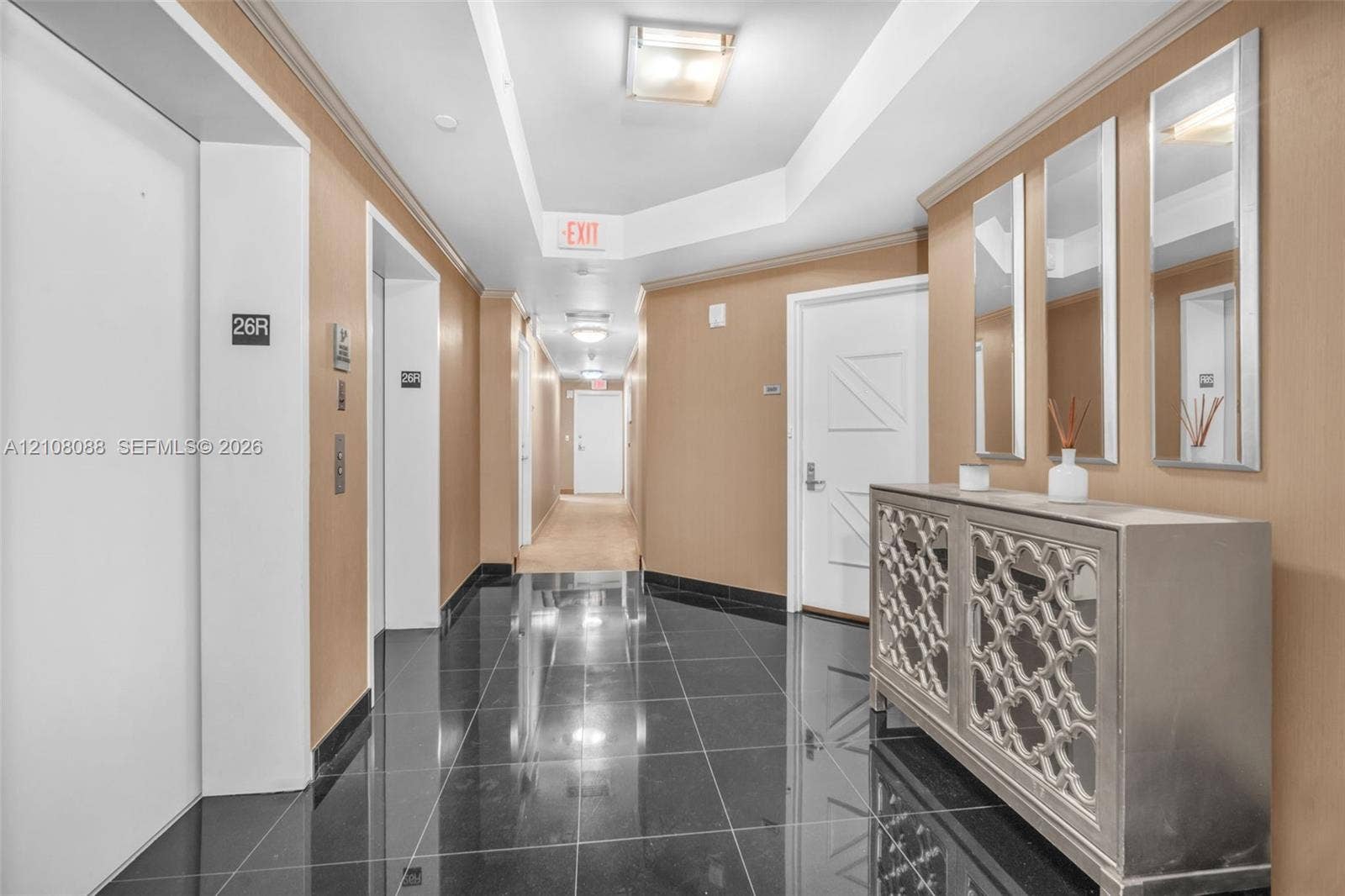 333 Las Olas Way, #2601, Fort Lauderdale, FL 33301 Polished black stone flooring, tray ceiling with recessed lighting, and wall-mounted flush-mount fixtures
