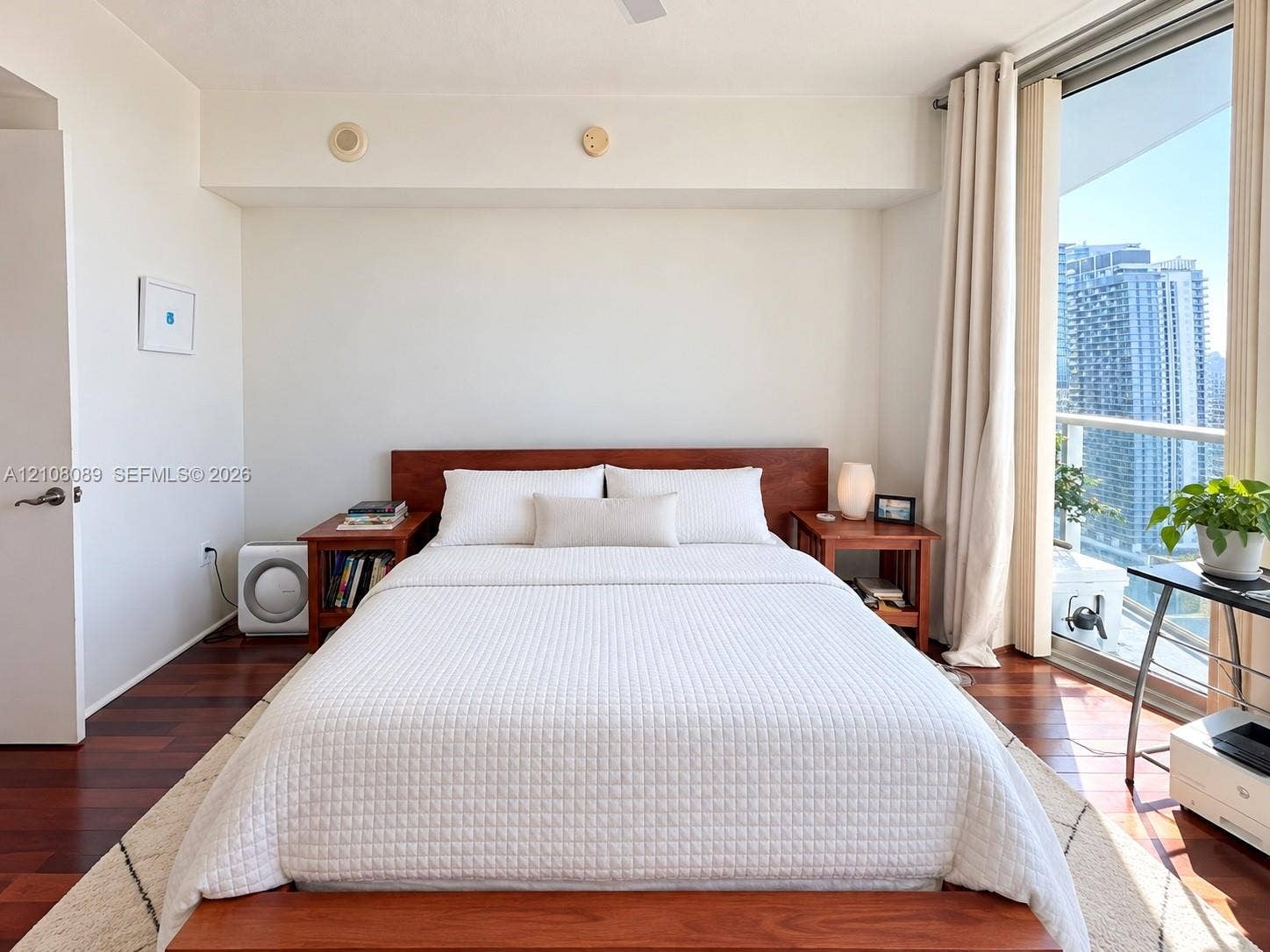 185 SW 7th Street, #3608, Miami, FL 33130 Wood-finish flooring, floor-to-ceiling glass wall, and balcony access
