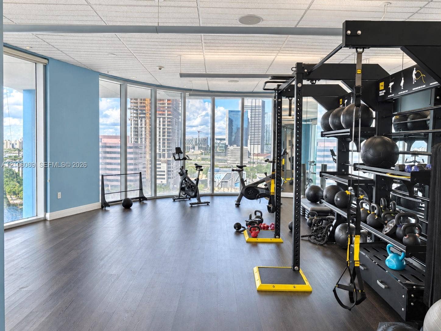185 SW 7th Street, #3608, Miami, FL 33130 Floor-to-ceiling windows featuring urban scenery, wood-finish flooring, and recessed ceiling lighting