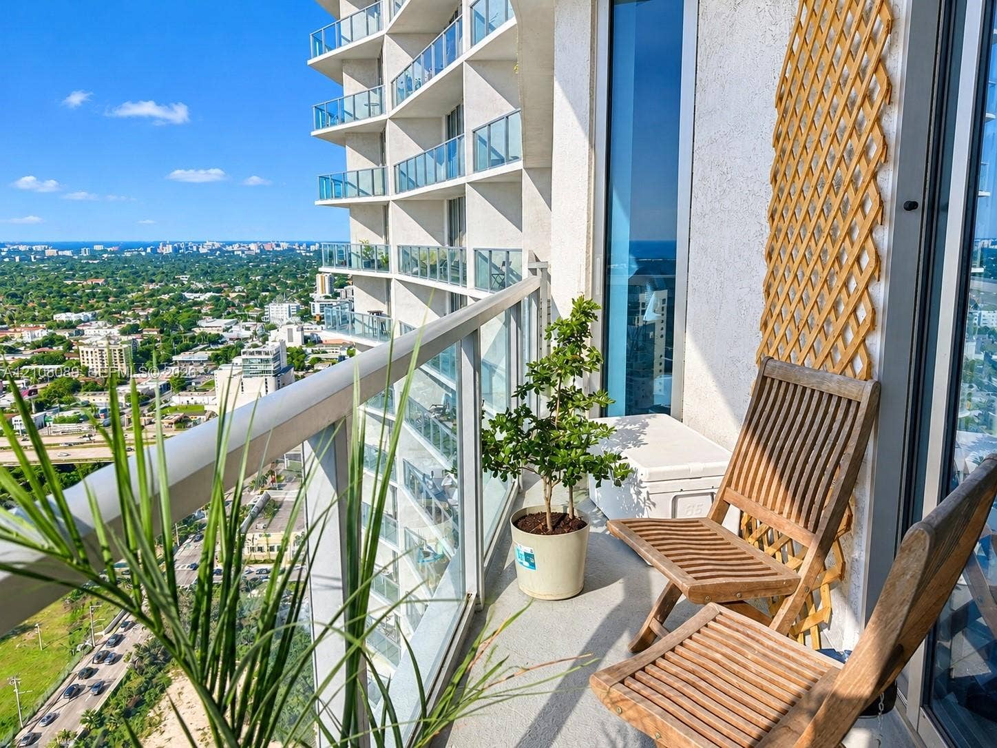 185 SW 7th Street, #3608, Miami, FL 33130 High-rise balcony featuring glass railings and panoramic urban scenery