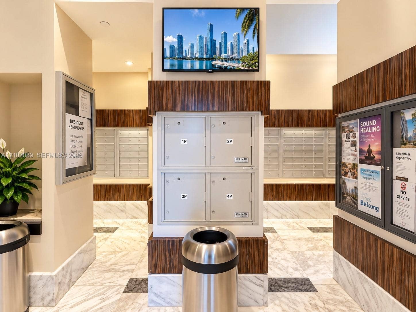 185 SW 7th Street, #3608, Miami, FL 33130 Mail center area featuring integrated parcel lockers, wood-finish wall paneling, and stone tile flooring