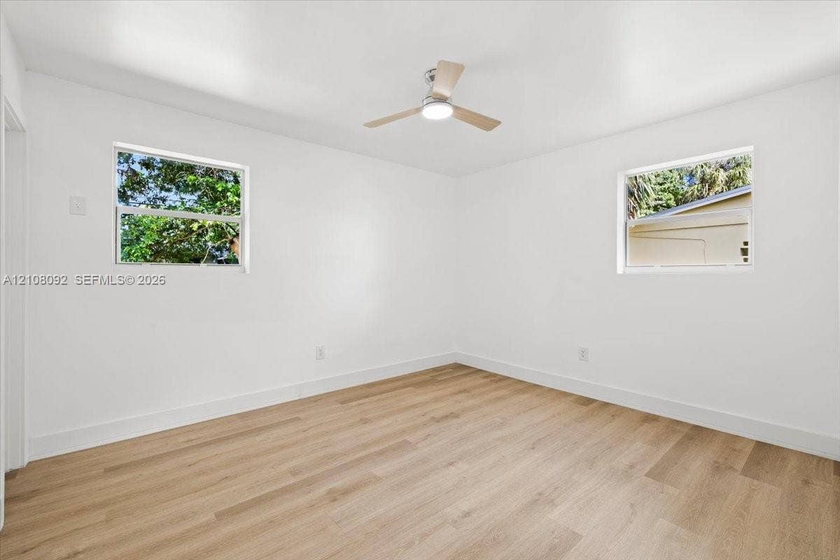 Dedicated laundry area featuring a white six-panel door and plumbing hookups for a top-load washer and dryer