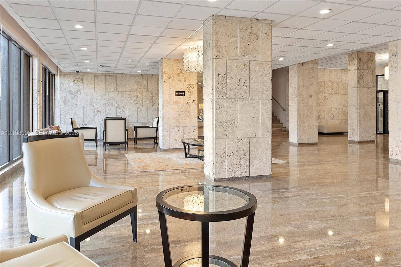 1965 S Ocean Drive, #6H, Hallandale Beach, Hallandale Beach, FL 33009 Lobby featuring polished stone flooring, floor-to-ceiling stone-clad structural columns, and recessed lighting throughout a drop ceiling