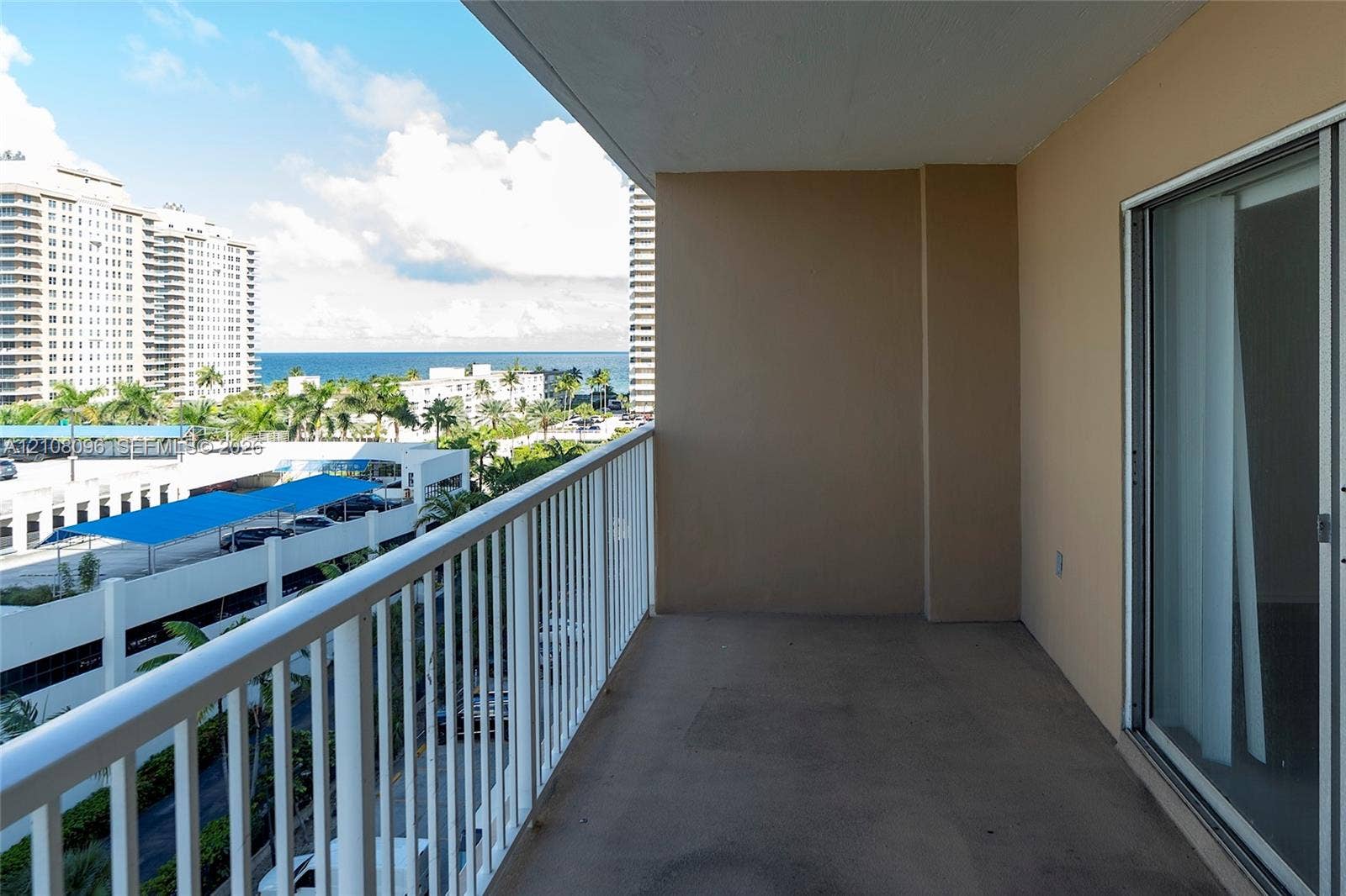 1965 S Ocean Drive, #6H, Hallandale Beach, Hallandale Beach, FL 33009 Covered balcony with white metal railings and sliding glass door entrance
