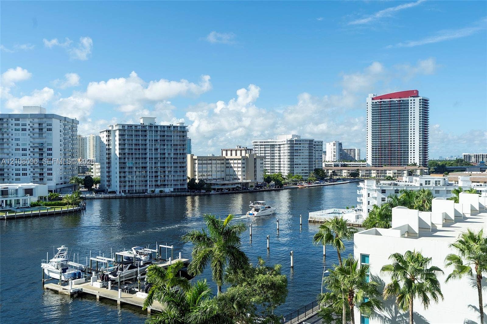 1965 S Ocean Drive, #6H, Hallandale Beach, Hallandale Beach, FL 33009 Waterfront setting featuring a private deep-water dock, mature palm trees, and expansive cityscape horizons