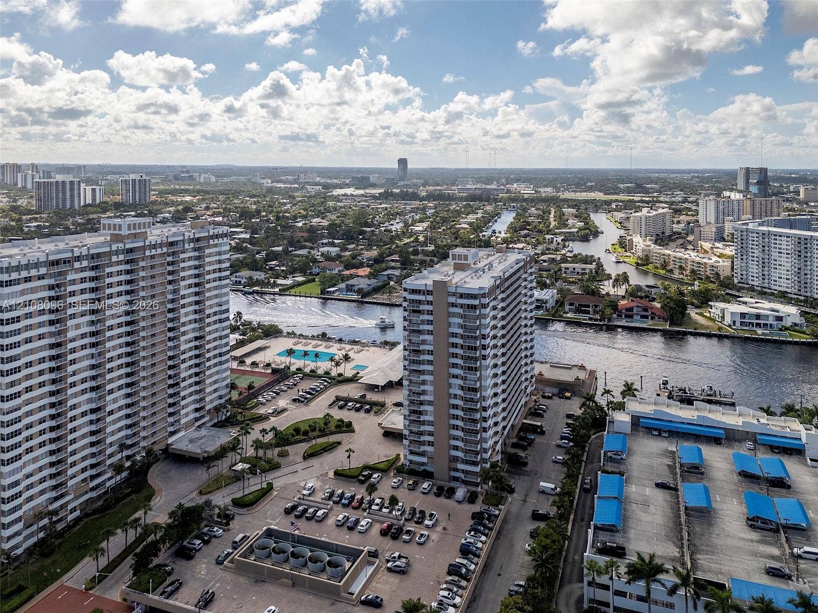 1965 S Ocean Drive, #6H, Hallandale Beach, Hallandale Beach, FL 33009 Aerial perspective of high-rise structures featuring paved surface parking, covered parking tiers, and waterfront proximity