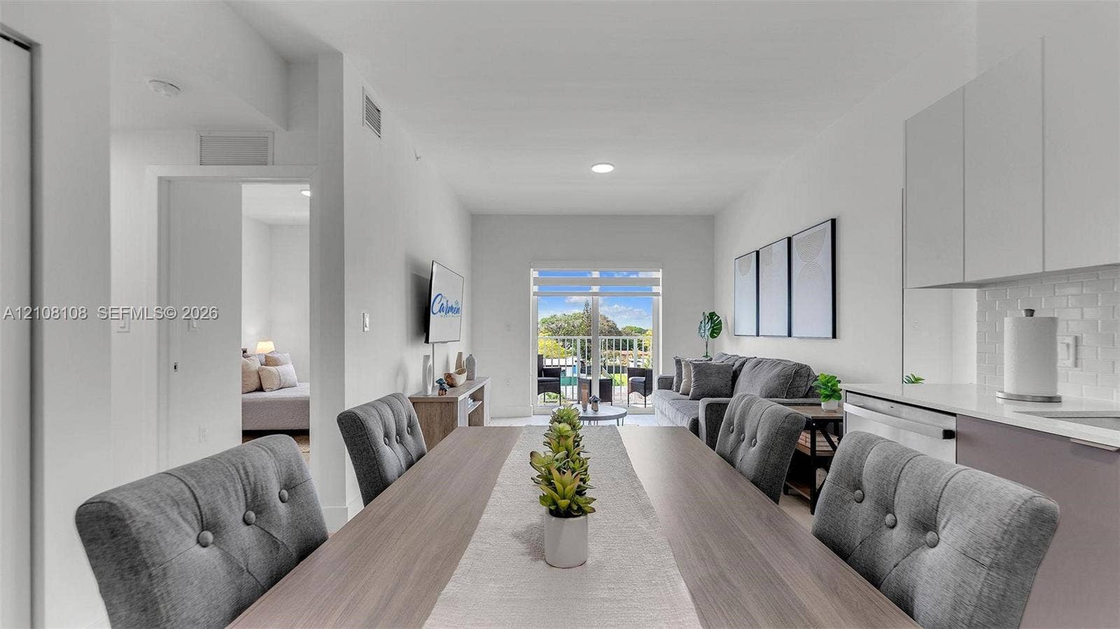 605 N Dixie Highway, #B207, Hallandale Beach, Hallandale Beach, FL 33009 Open-concept living space featuring high ceilings, recessed lighting, and sliding glass doors providing outdoor access