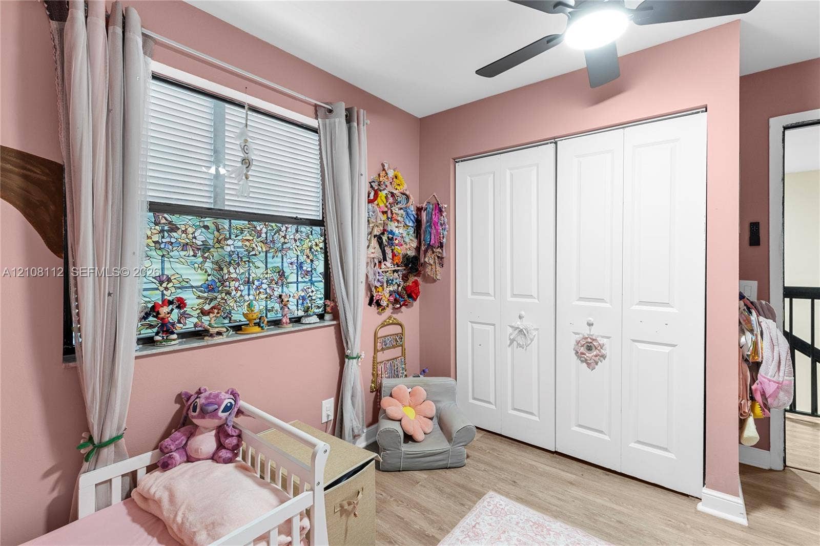 1431 NW 112th Terrace, Pembroke Pines, FL 33026 Room featuring wood-finish flooring, a double-door reach-in closet, and a ceiling fan with integrated lighting