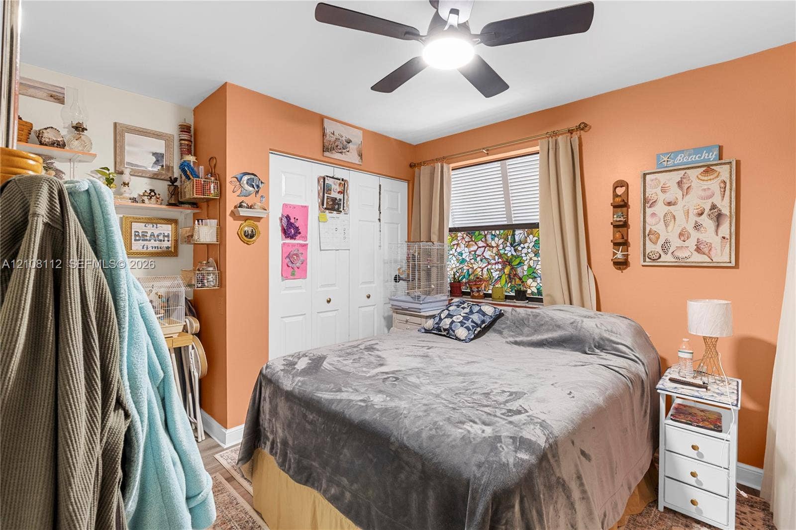 1431 NW 112th Terrace, Pembroke Pines, FL 33026 Room featuring a ceiling fan with integrated lighting, bi-fold closet doors, and decorative stained-glass window paneling