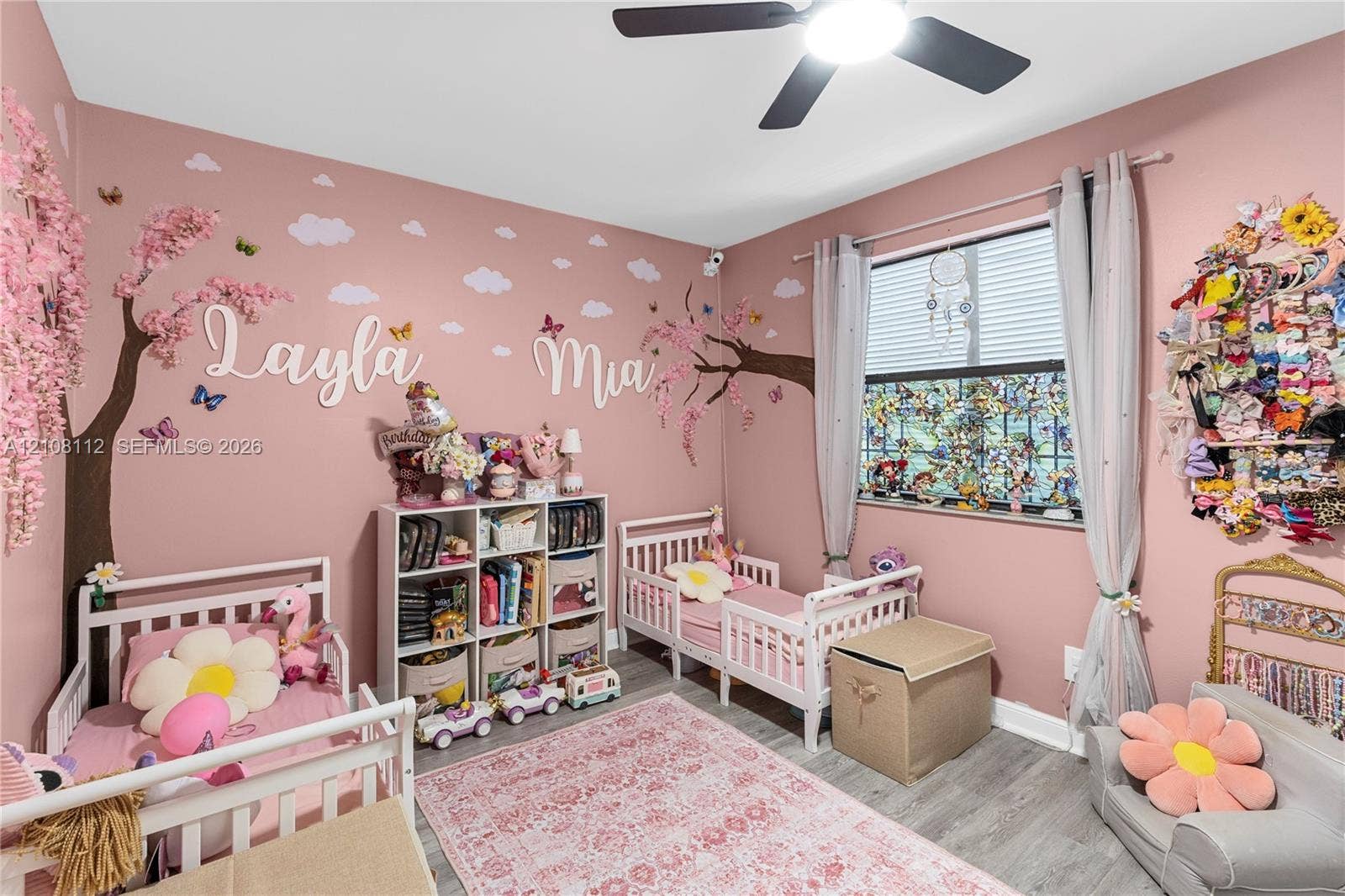 1431 NW 112th Terrace, Pembroke Pines, FL 33026 Wood-finish flooring, large window with horizontal blinds, and a multi-blade ceiling fan with integrated lighting