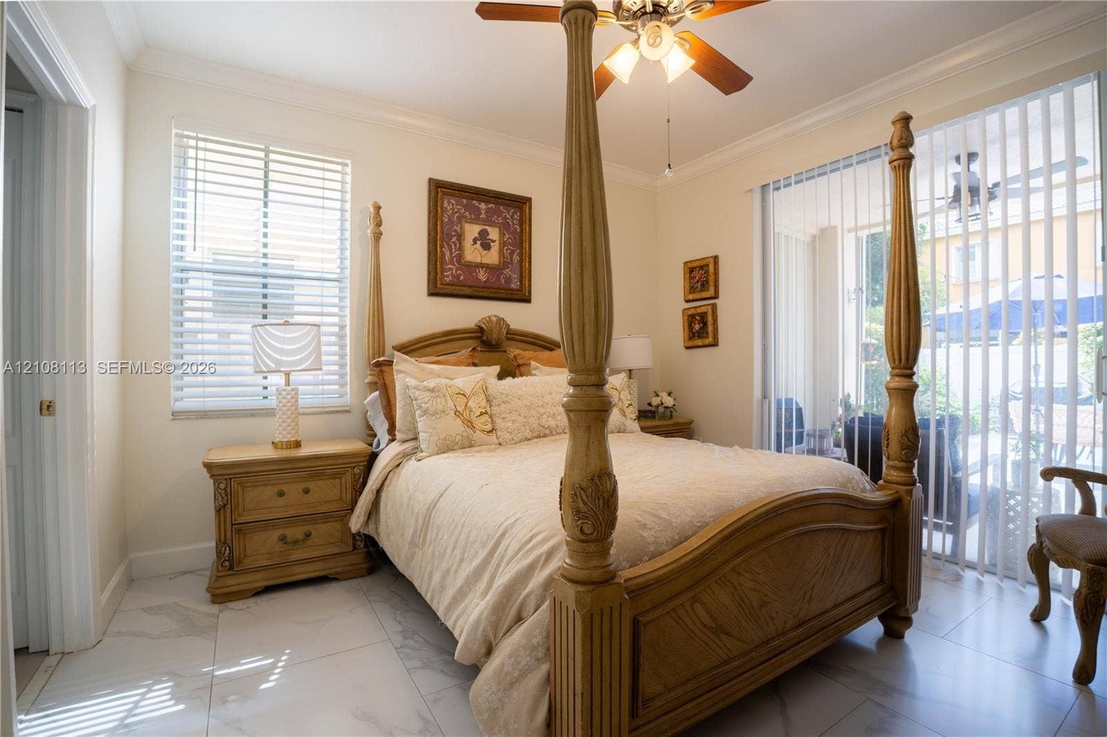 2294 SW 126th Avenue, Miramar, FL 33027 Large-format tile flooring, crown molding, ceiling fan with integrated lighting, and sliding glass doors with vertical blinds