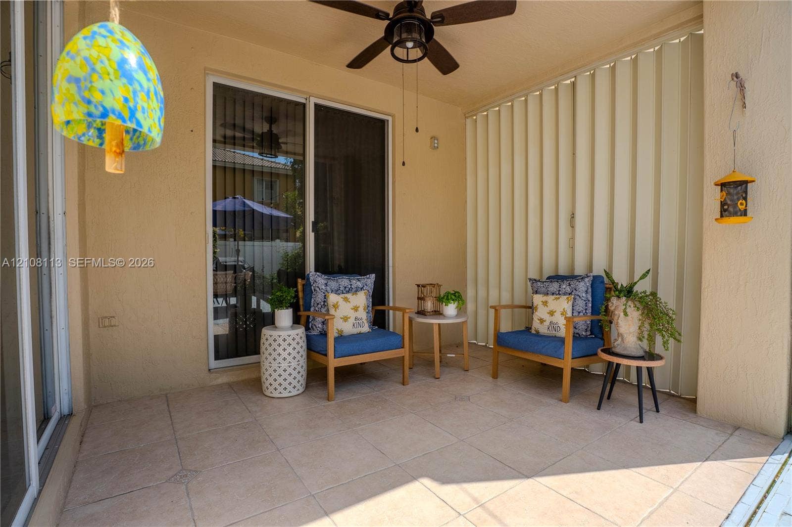 2294 SW 126th Avenue, Miramar, FL 33027 Covered patio featuring large-format tile flooring, a ceiling fan, and sliding glass entry doors with vertical blinds