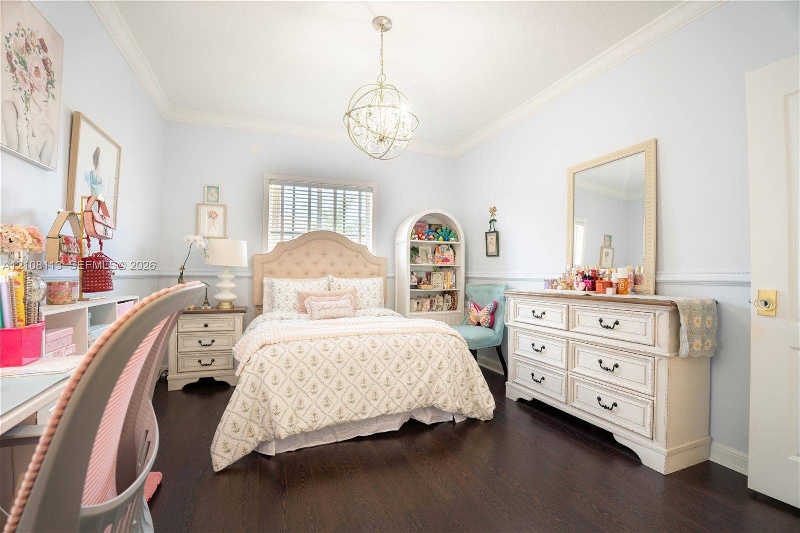 2294 SW 126th Avenue, Miramar, FL 33027 Room featuring dark wood-finish flooring, crown molding, chair rail trim, and a decorative orb-style chandelier