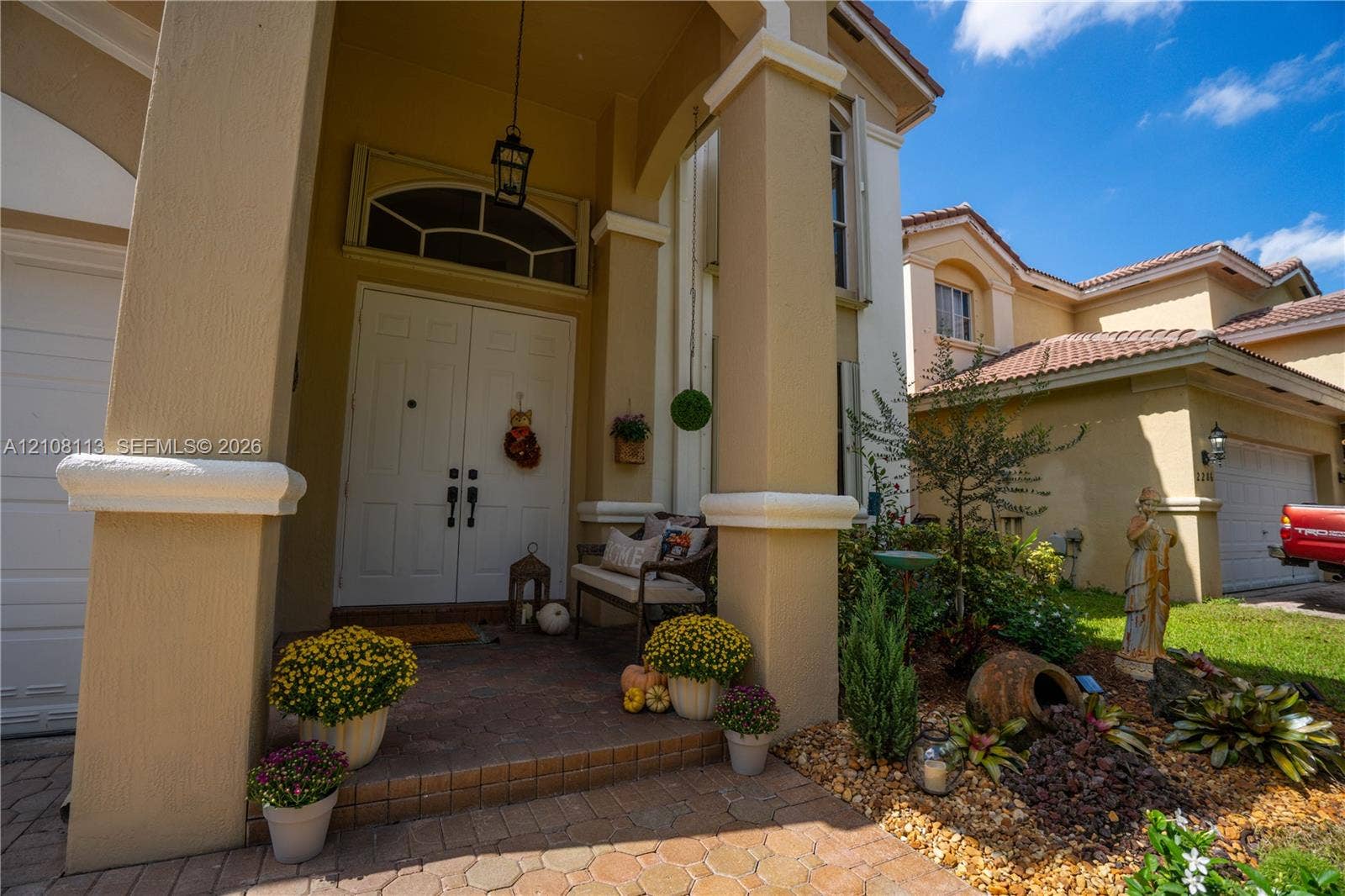 2294 SW 126th Avenue, Miramar, FL 33027 Covered entryway with double front doors, arched transom window, paver flooring, and substantial structural columns