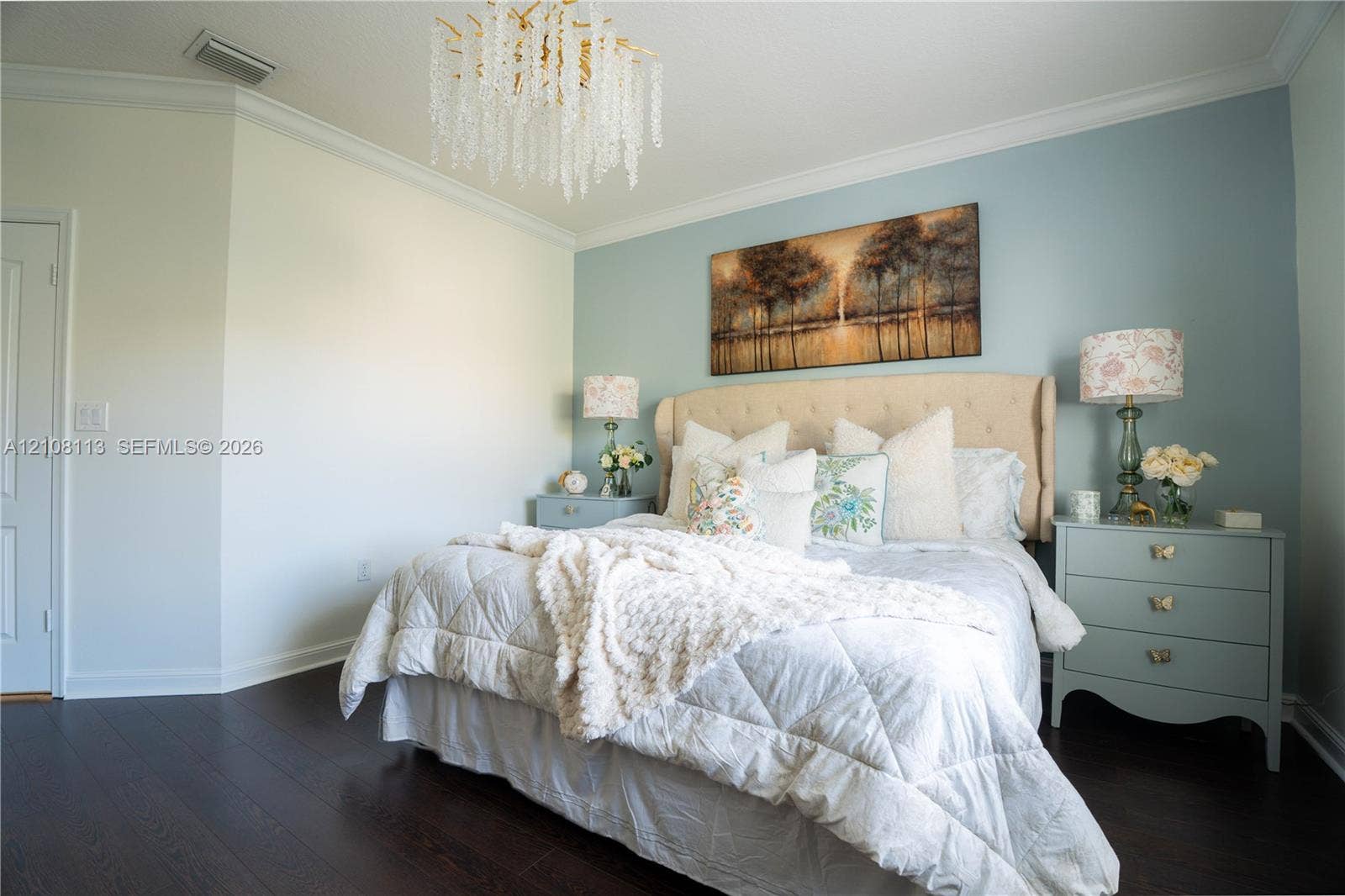 2294 SW 126th Avenue, Miramar, FL 33027 Room featuring dark wood-finish flooring, crown molding, and a tiered crystal chandelier