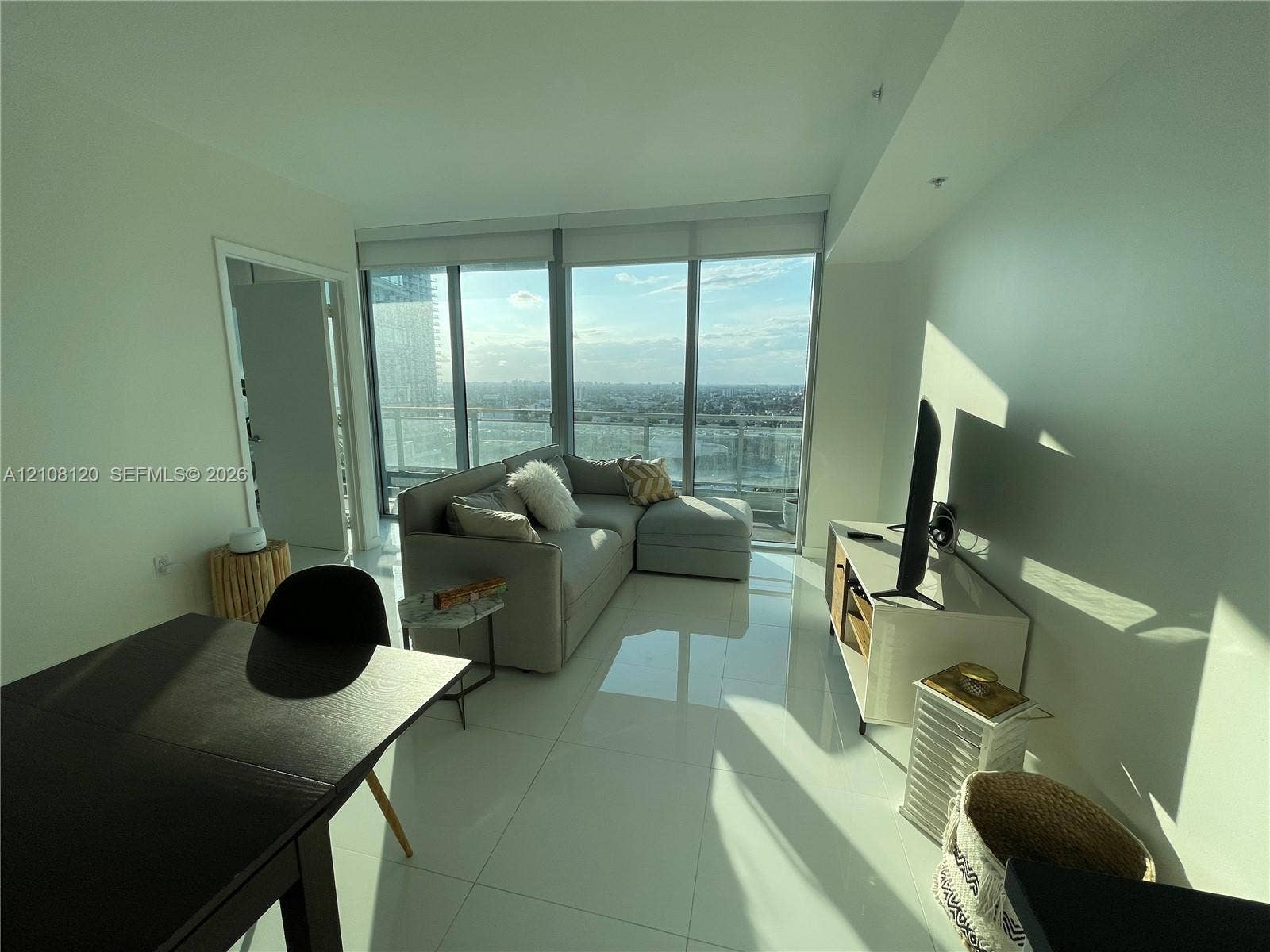 92 SW 3rd Street, #2307, Miami, FL 33130 Floor-to-ceiling windows, high-gloss tile flooring, and a private balcony featuring a glass railing